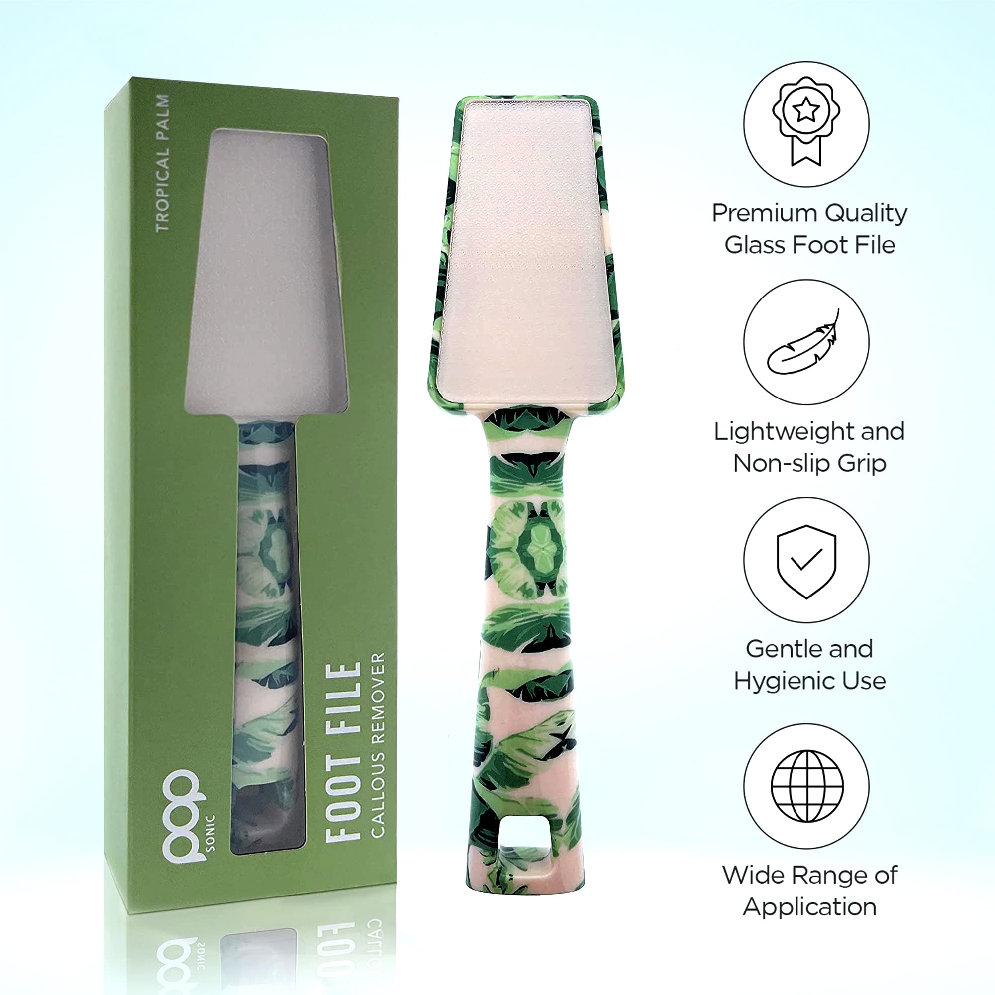 Tropical-patterned Foot file with green palm leaf design and packaging on a light blue background with key features: Premium Quality Glass Foot FIle, Lightweight and Non-slip Grip, Gentle and Hygienic Use, and Wide Range of Application.