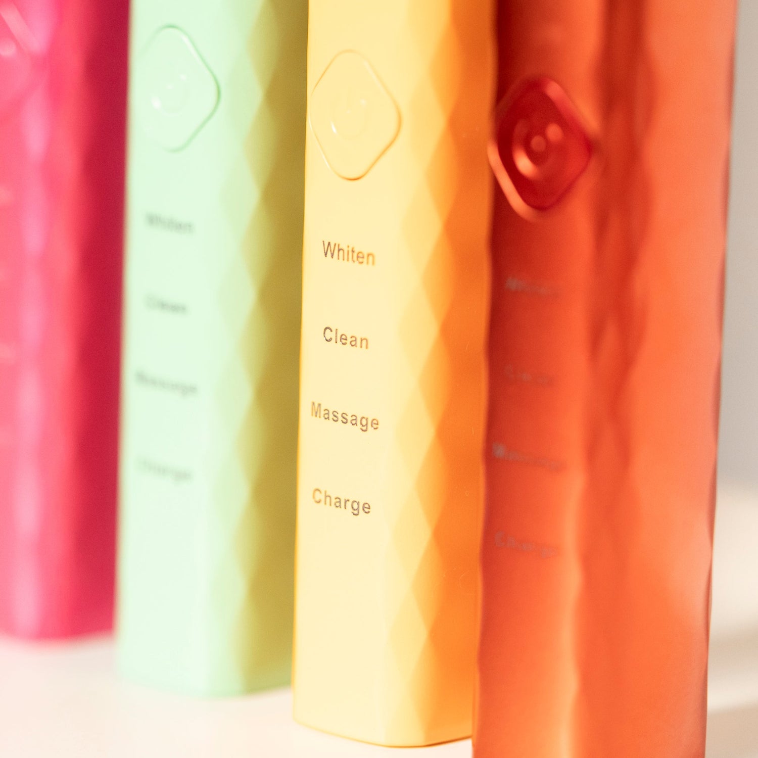 Close-up of multiple colorful toothbrushes on a white background
