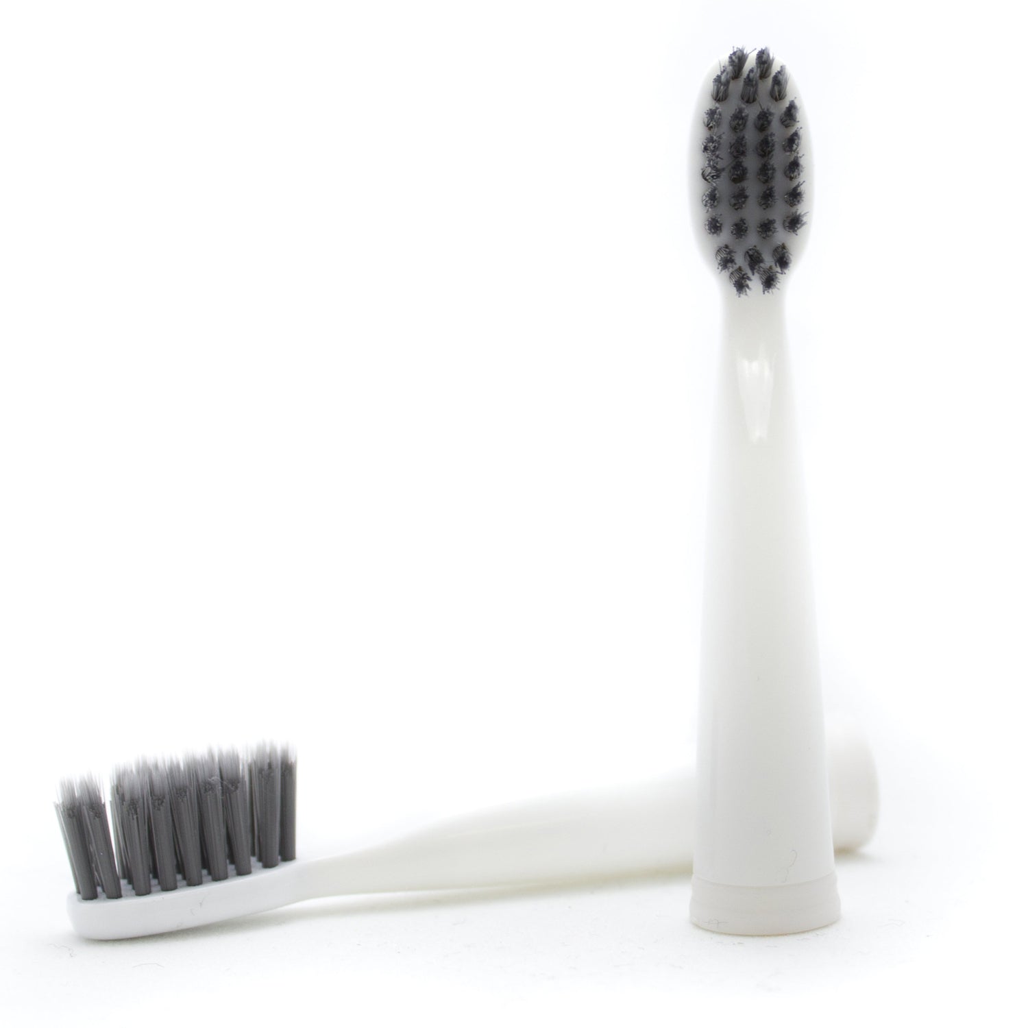 Two white toothbrushes with black bristles on a white background