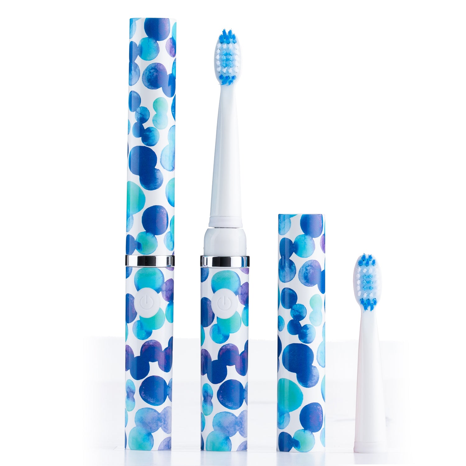 Set of electric toothbrushes with blue and white polka dot design on a white background
