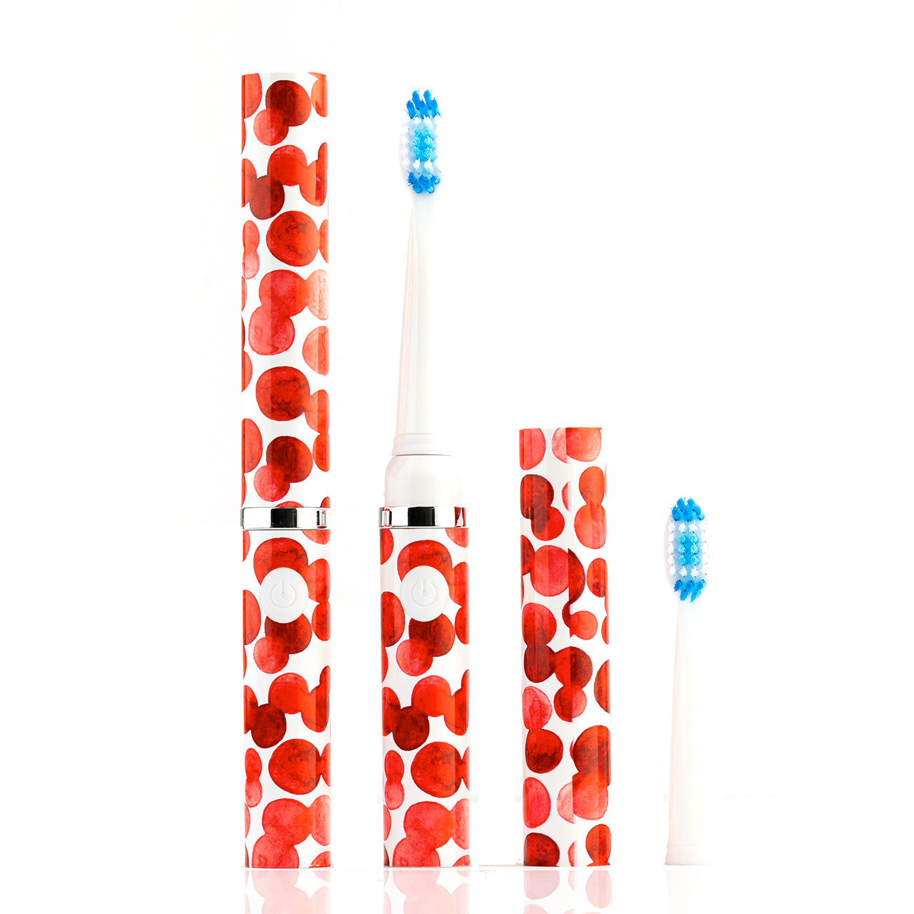 Electric toothbrush with red and white polka dot design on a white background
