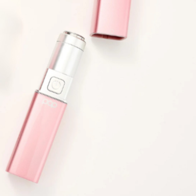 Pink electronic device with silver top on a white background