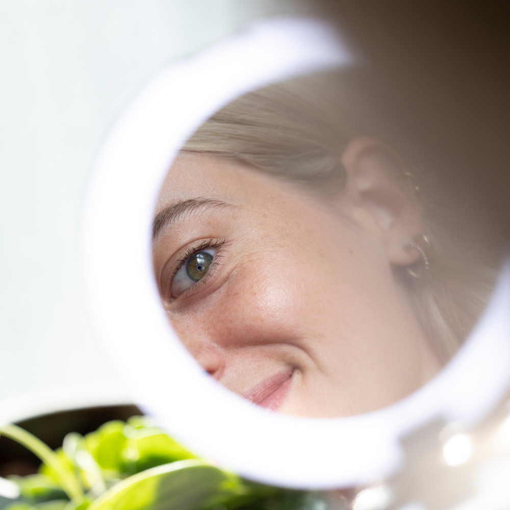 LED Circle Mirror Light On with woman looking back at herself in the mirror
