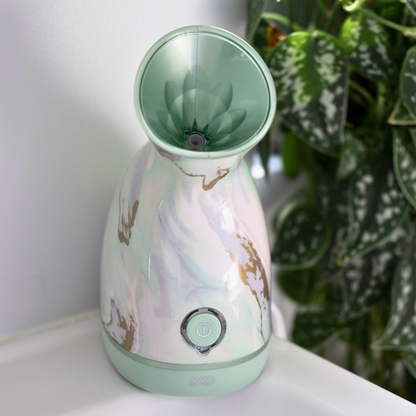 Image of the Nano Facial Steamer on a bathroom counter in the Marble color.