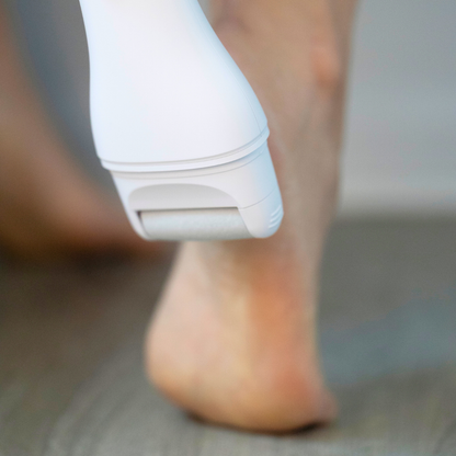 Pedi Pro 2.0 in the color white next to  the bottom of a woman&