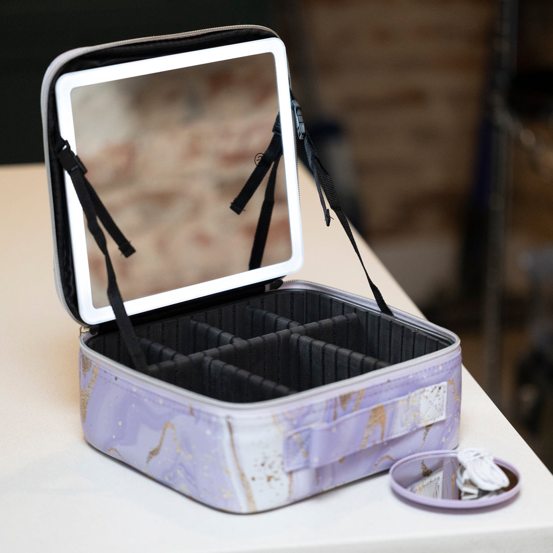 LED Makeup and Nailcare Cosmetic Case in Purple Marble displayed open on a counter, with the LED mirror on