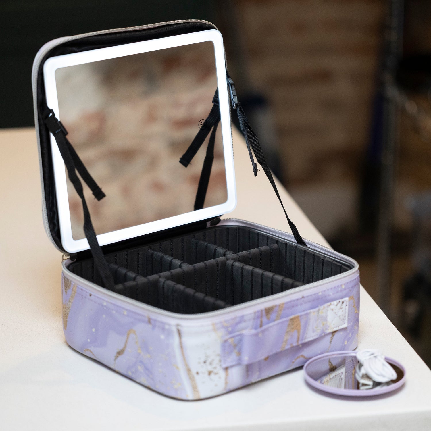 LED Makeup and Nailcare Cosmetic Case in Purple Marble displayed open on a counter, with the LED mirror on