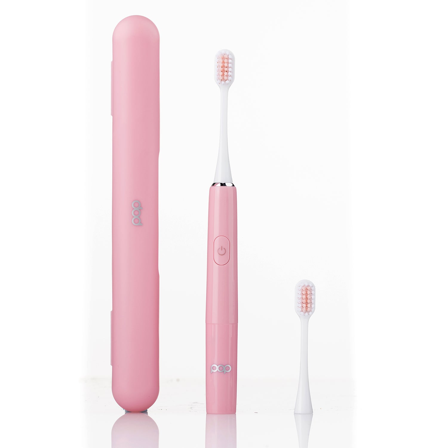 Pink electric toothbrush with travel case on a white background