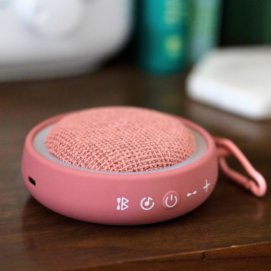 Pink White Noise Sound Machine sitting on a wood table