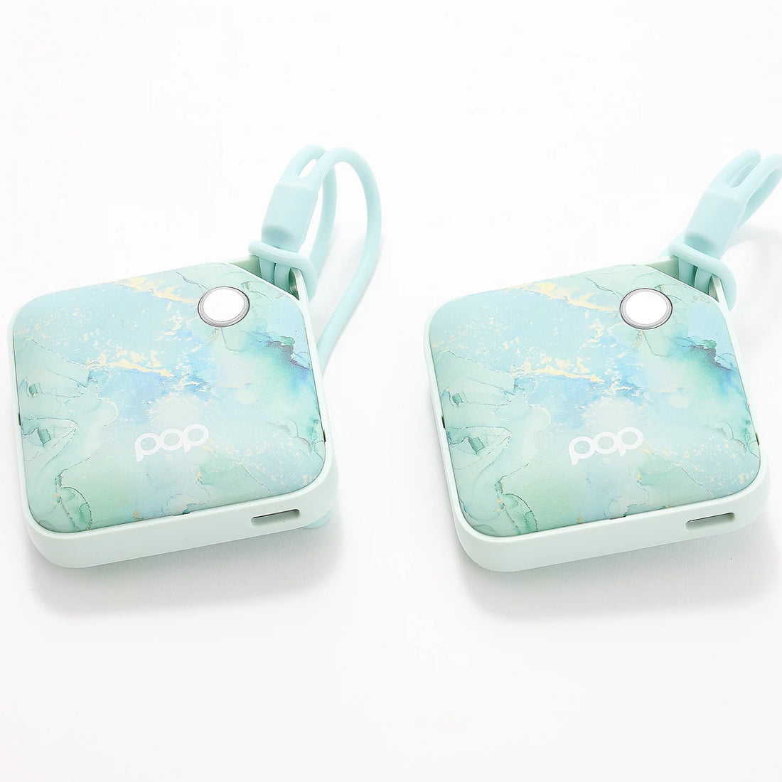 A pair of the Blue Marble colored USB Rechargeable Handwarmers with a white background